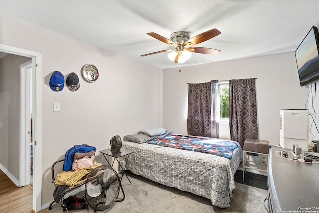 bedroom featuring wood-type flooring and ceiling fan