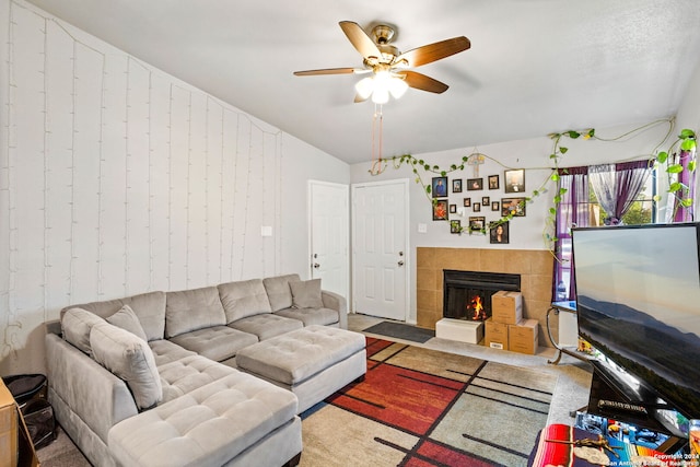 living room featuring a fireplace, ceiling fan, lofted ceiling, and carpet flooring