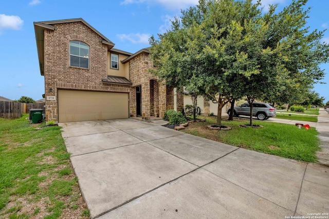 view of front of house featuring a garage and a front lawn