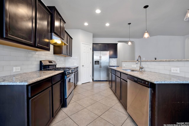 kitchen featuring stainless steel appliances, sink, decorative light fixtures, decorative backsplash, and light stone countertops