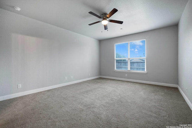 spare room with ceiling fan and carpet