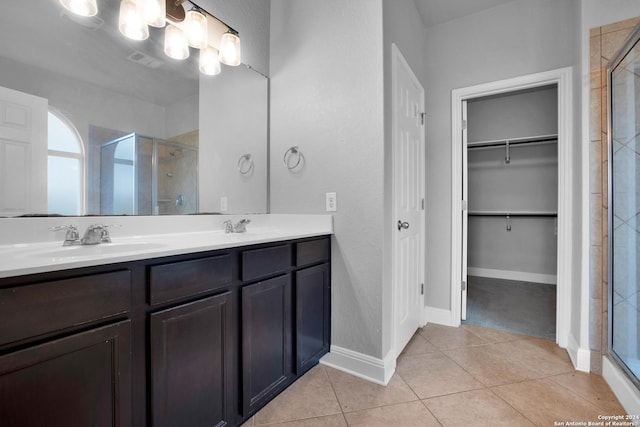 bathroom with vanity, tile patterned flooring, and a shower with door