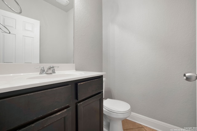 bathroom with vanity, tile patterned floors, and toilet