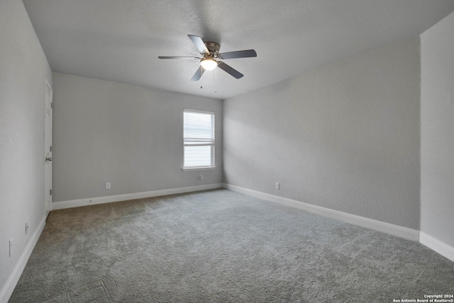 unfurnished room featuring ceiling fan, carpet floors, and a textured ceiling