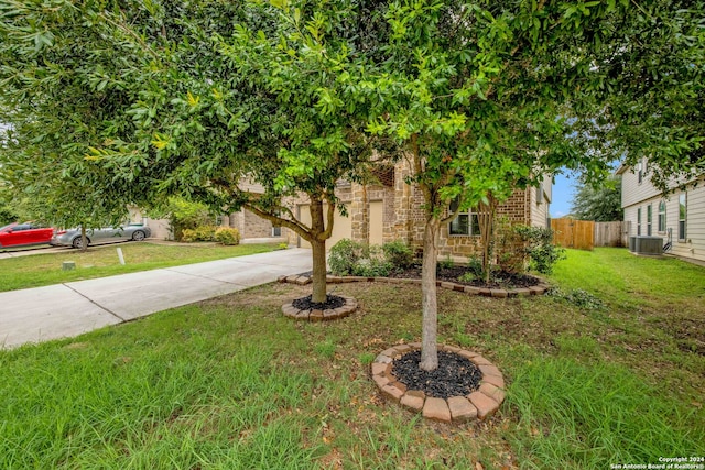 view of property hidden behind natural elements featuring a front yard