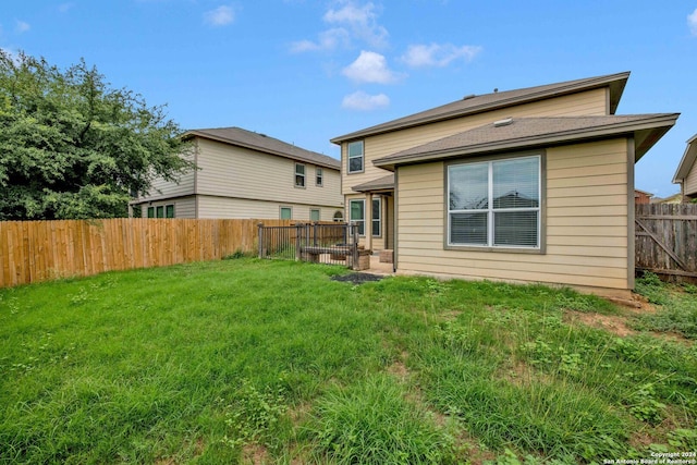 rear view of house with a lawn