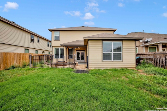 back of house featuring a yard, a patio area, and french doors