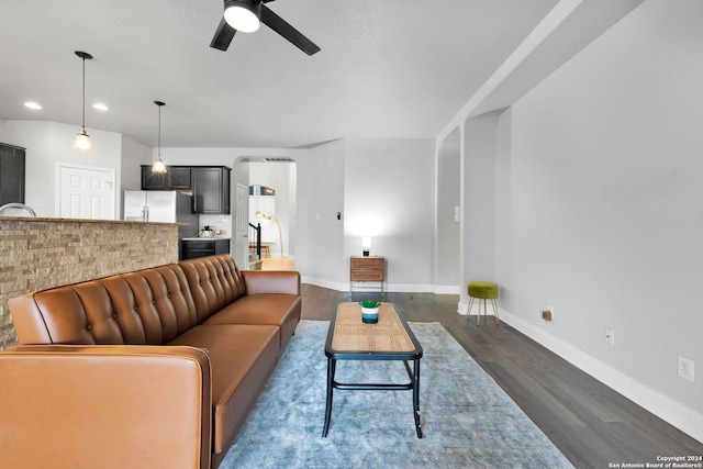 living room with ceiling fan and dark hardwood / wood-style floors