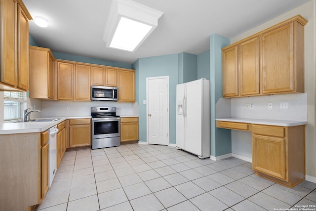 kitchen featuring sink, light brown cabinets, light tile patterned floors, and appliances with stainless steel finishes