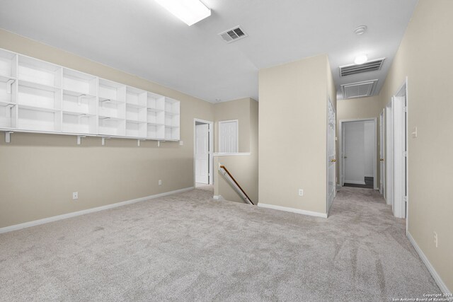 unfurnished room with light carpet, ceiling fan, and vaulted ceiling