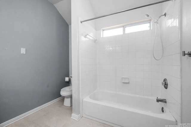 bathroom featuring tiled shower / bath, tile patterned floors, and toilet