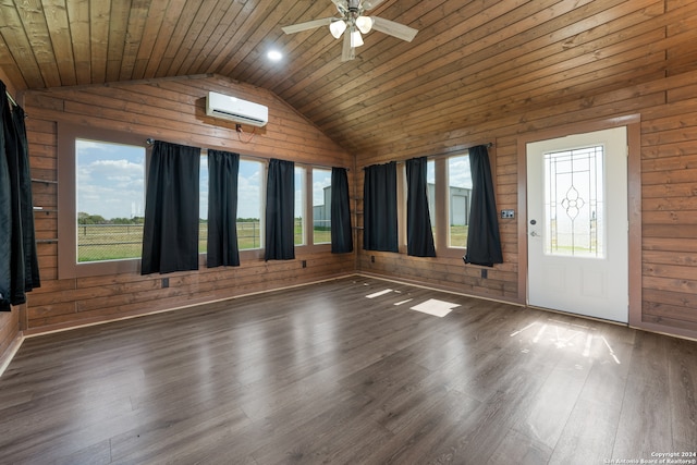 interior space with wooden ceiling, a wealth of natural light, wooden walls, and dark hardwood / wood-style floors