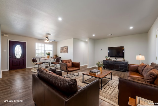 living room with dark wood-type flooring and ceiling fan