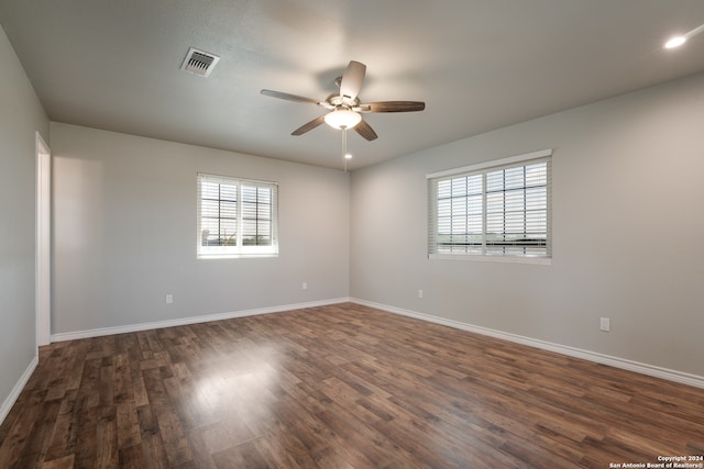 spare room featuring ceiling fan and dark hardwood / wood-style flooring