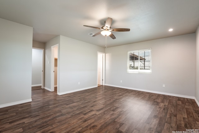 empty room with dark hardwood / wood-style floors and ceiling fan