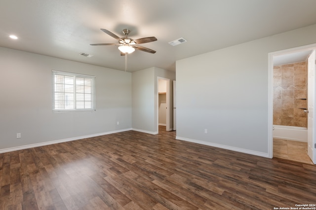 empty room featuring ceiling fan and dark hardwood / wood-style flooring