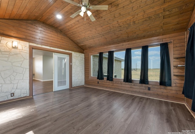 10886 Macaway Rd, Adkins, TX 78101 - empty room with wooden walls, vaulted ceiling, wooden ceiling, a ceiling fan, and wood finished floors