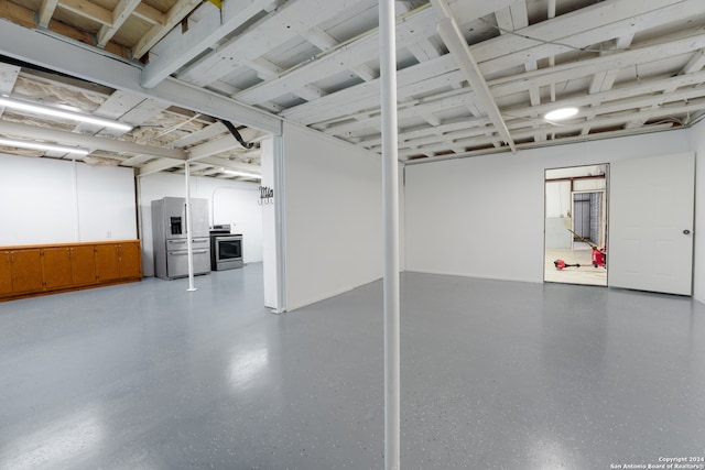 basement featuring stainless steel fridge