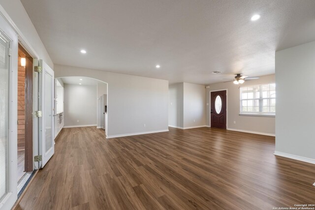 10886 Macaway Rd, Adkins, TX 78101 - entrance foyer featuring arched walkways, ceiling fan, dark wood-style flooring, baseboards, and recessed lighting