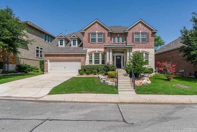 view of front of house with a garage and a front lawn