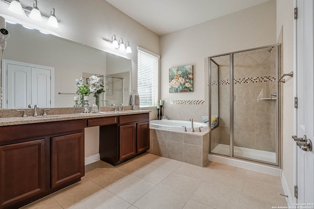 bathroom featuring plus walk in shower, tile patterned floors, and double vanity