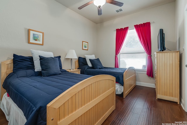 bedroom with ceiling fan and dark hardwood / wood-style flooring