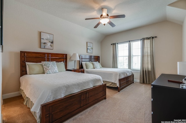 carpeted bedroom with a textured ceiling, ceiling fan, and vaulted ceiling