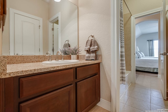 bathroom featuring tile patterned flooring and vanity