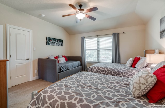 bedroom featuring lofted ceiling, light colored carpet, and ceiling fan