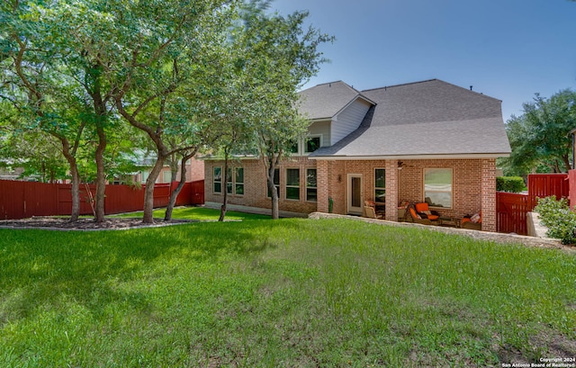 rear view of house with a yard