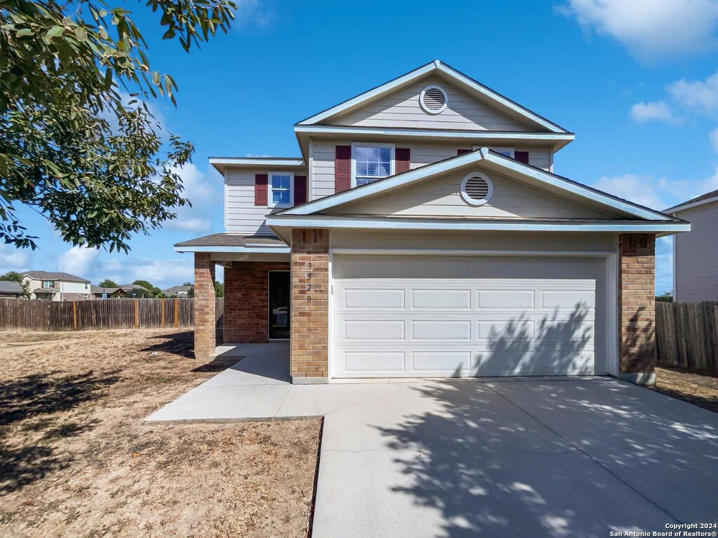 view of front facade with a garage and a front lawn