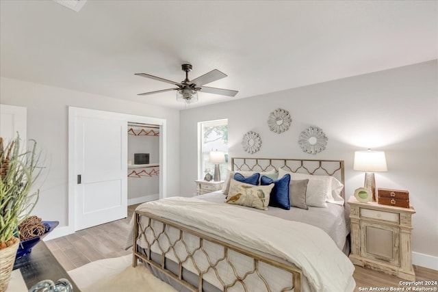 bedroom with light wood-type flooring and ceiling fan