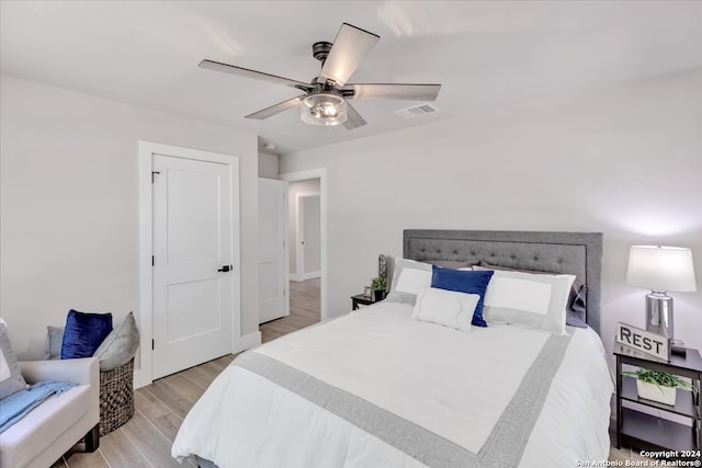 bedroom with ceiling fan and light hardwood / wood-style flooring