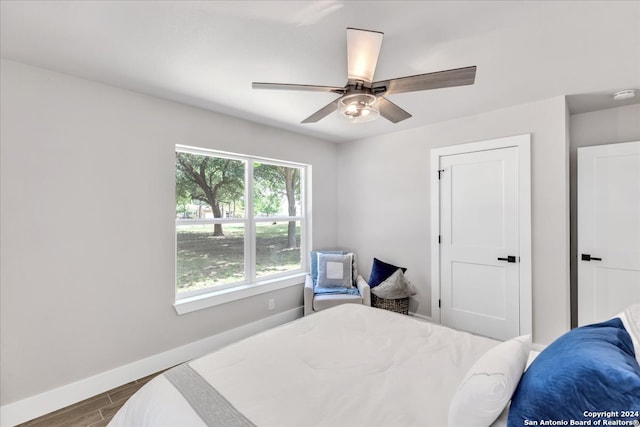 bedroom with ceiling fan and hardwood / wood-style flooring