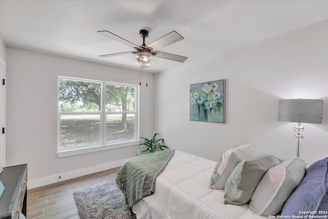 bedroom featuring light wood-type flooring and ceiling fan