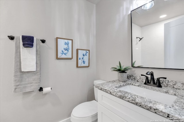 bathroom featuring toilet and vanity