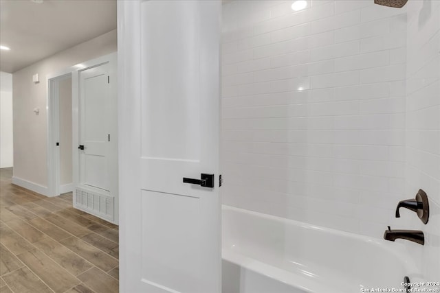 bathroom featuring tub / shower combination and hardwood / wood-style floors