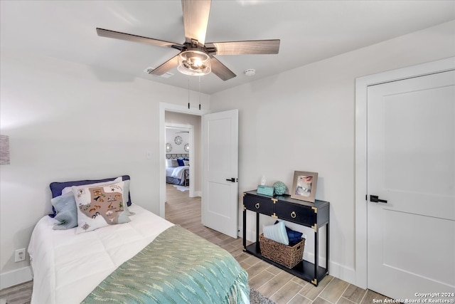 bedroom with light hardwood / wood-style flooring and ceiling fan