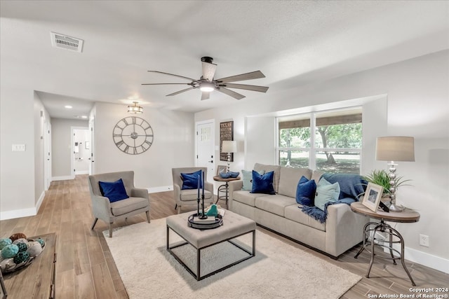 living room with light hardwood / wood-style floors and ceiling fan