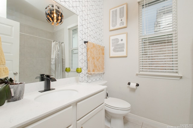 bathroom with vanity, tile patterned floors, a wealth of natural light, and toilet