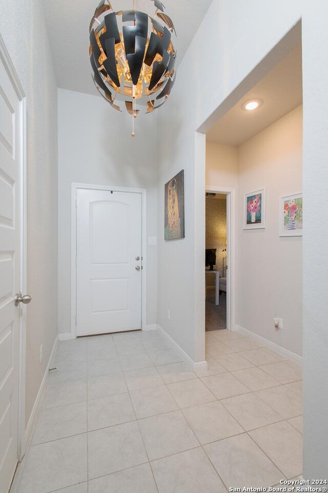 foyer with a chandelier and tile patterned flooring