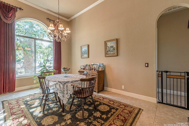 dining area with ornamental molding, a chandelier, and light tile patterned flooring