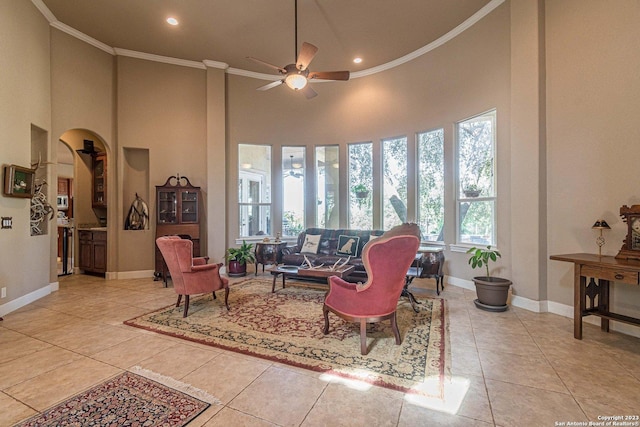 living room with crown molding, a healthy amount of sunlight, light tile patterned floors, and ceiling fan