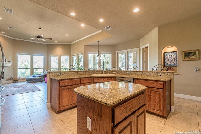 kitchen featuring ornamental molding, a large island, light tile patterned flooring, and decorative light fixtures