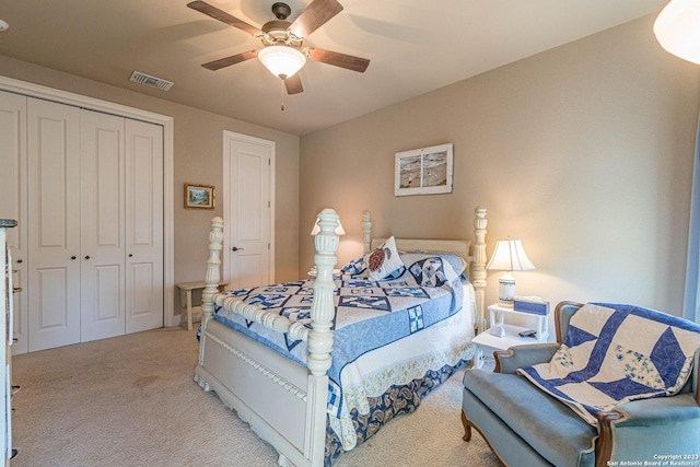 carpeted bedroom with ceiling fan and a closet