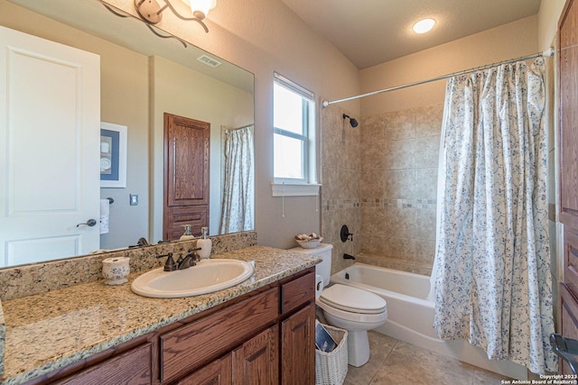 full bathroom featuring vanity, tile patterned floors, shower / bath combination with curtain, and toilet