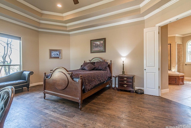 bedroom with crown molding, dark hardwood / wood-style floors, and a raised ceiling