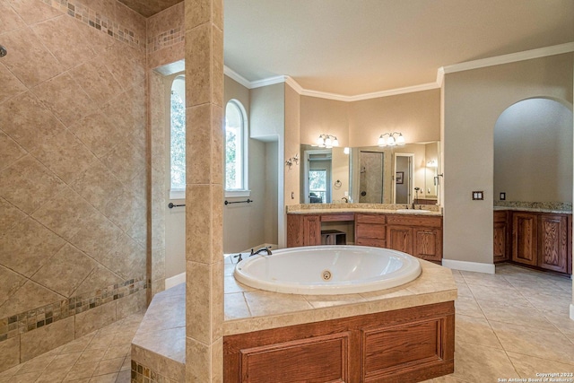 bathroom featuring tile patterned flooring, vanity, tiled bath, and crown molding