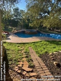 view of swimming pool with a patio area