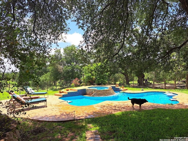 view of pool featuring an in ground hot tub and a patio